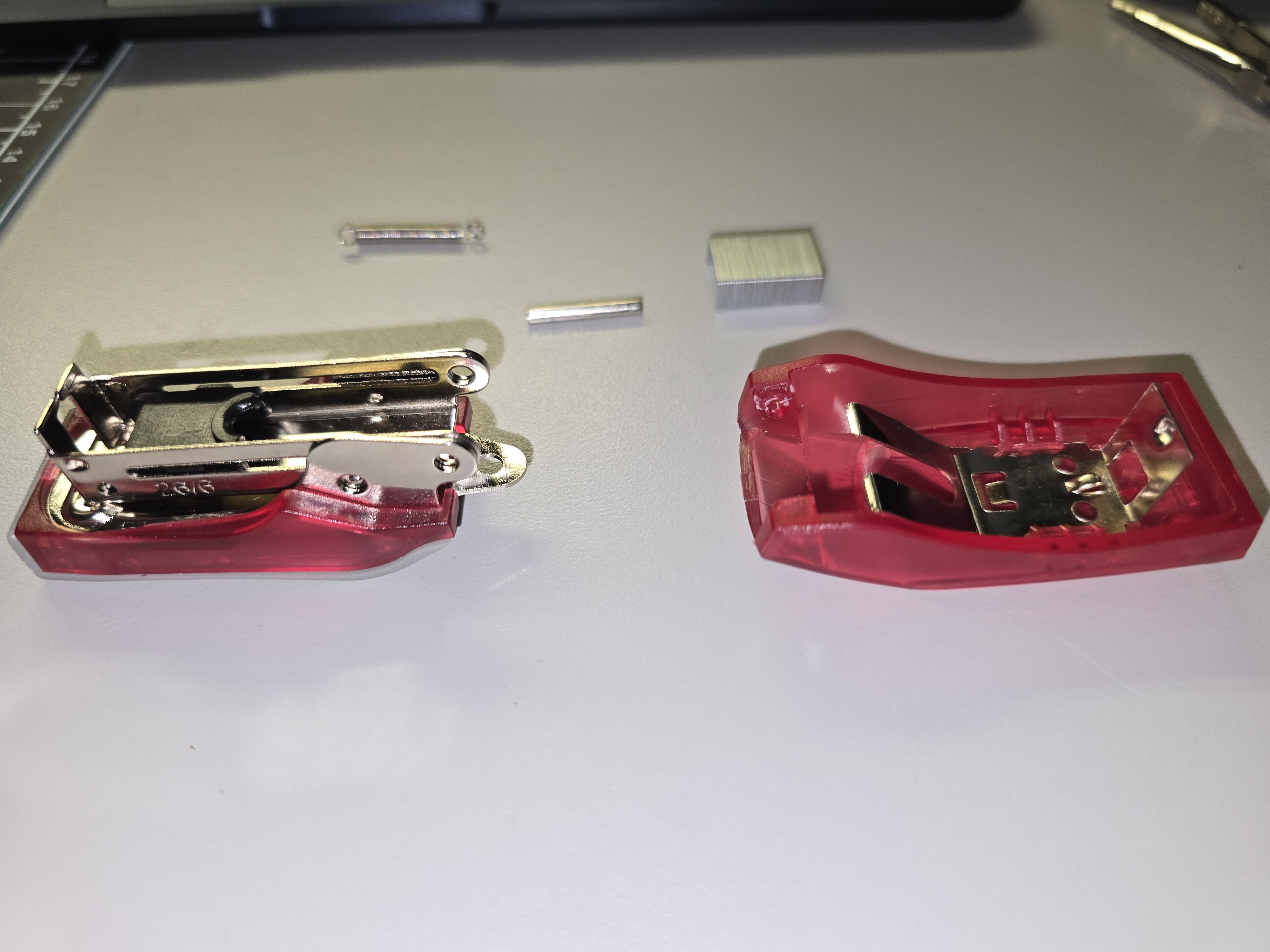 Disassembling the stapler to inspect the internal mechanism and component layout