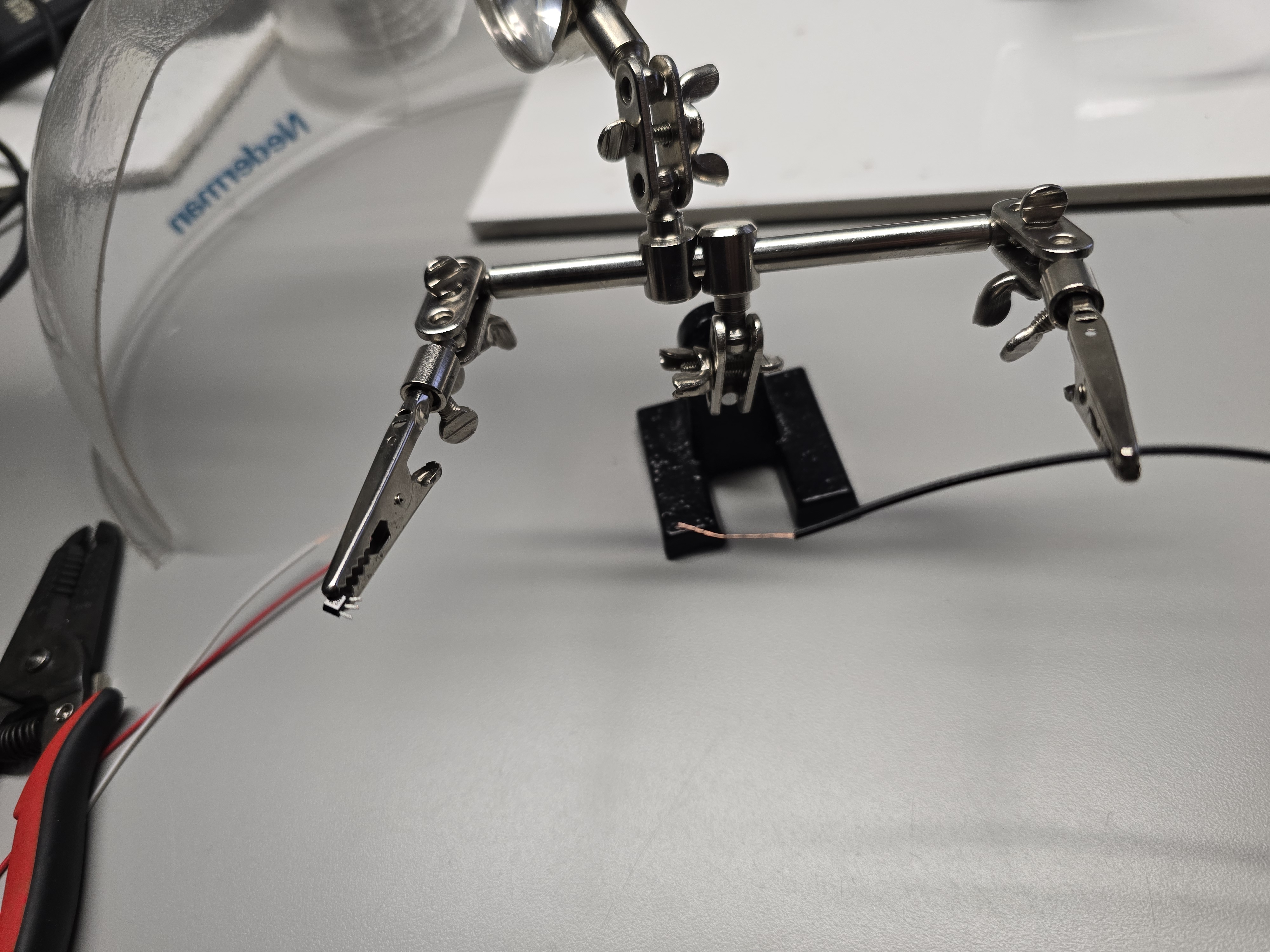 Helping hands holding stripped leads for Hall sensor extensions