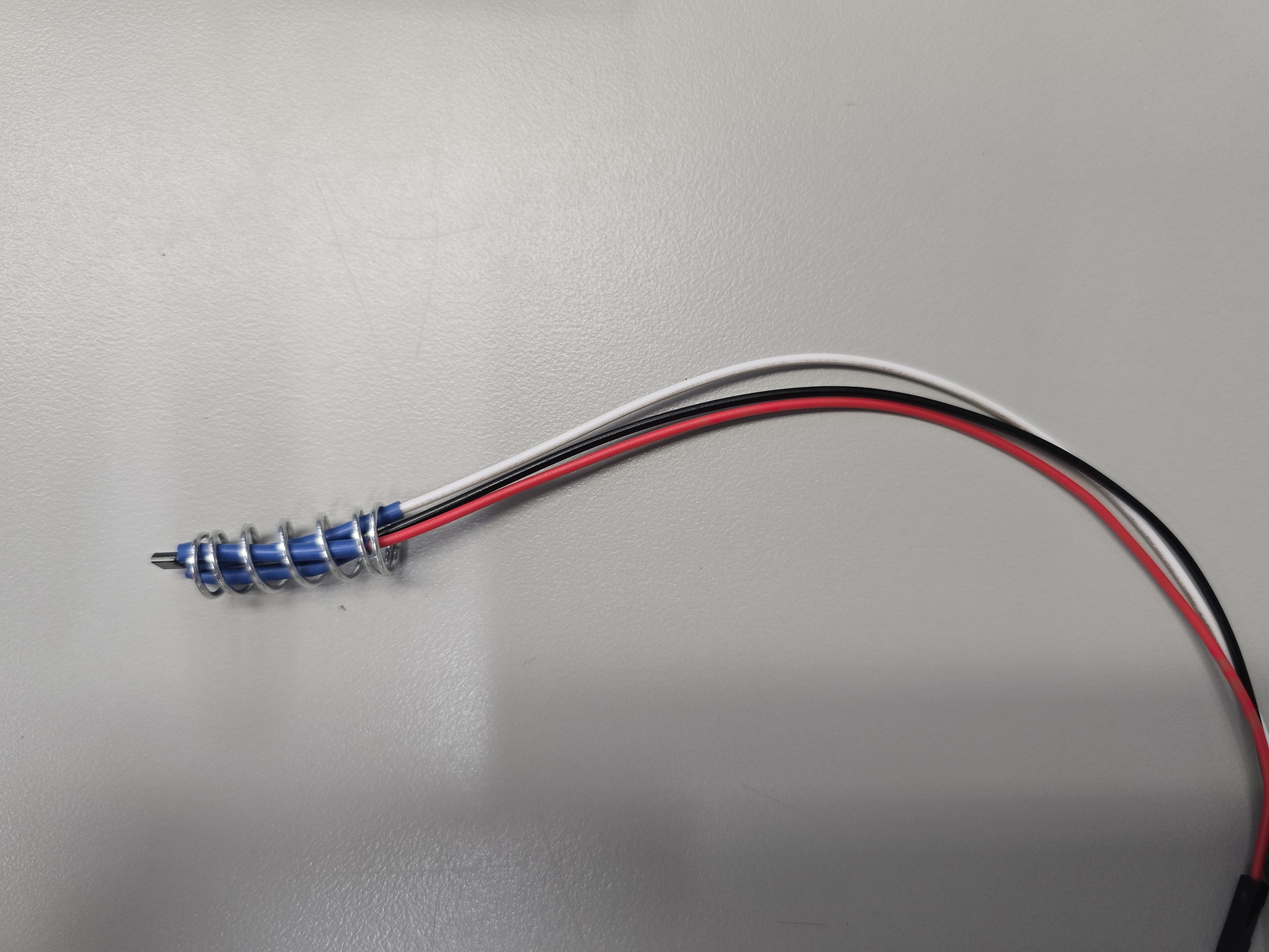 Hall sensor extension harness with protective spring