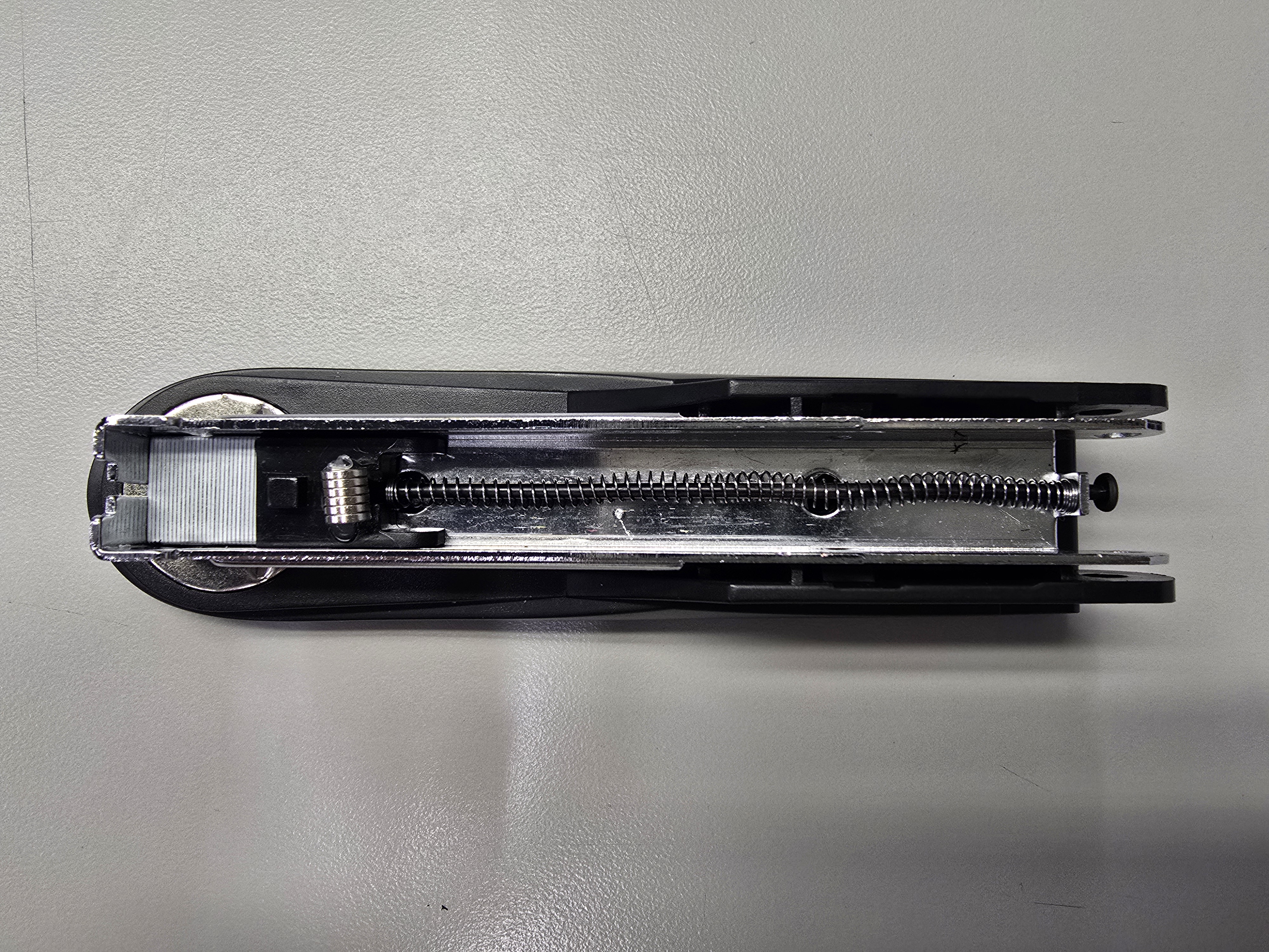 Stapler carriage reassembled with magazine spring
